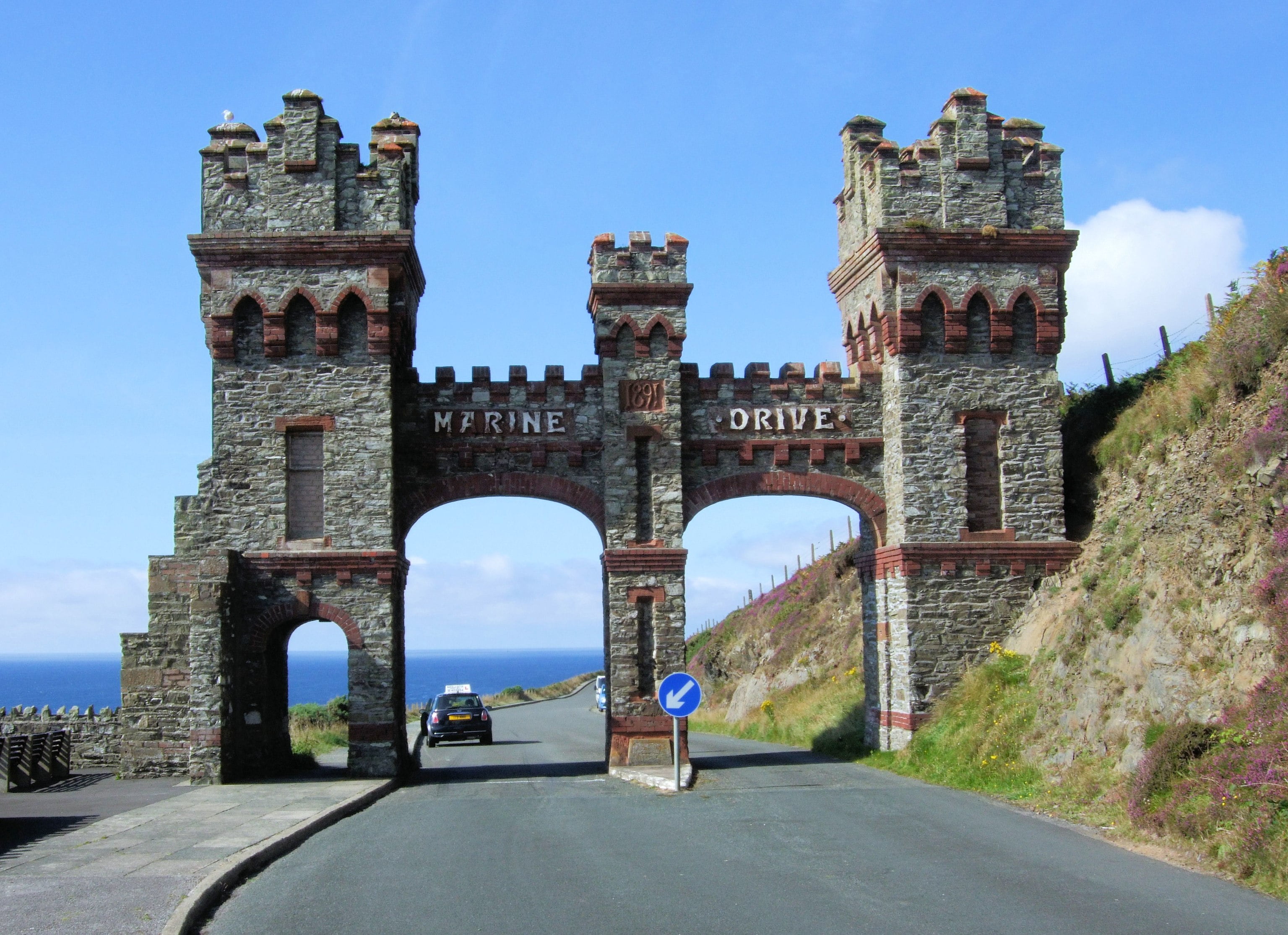 Man - Marine Drive was a toll road, and the impressive arched gateway was the toll gate. Man - Marine Drive was a toll road, and the impressive arched gateway was the toll gate.
