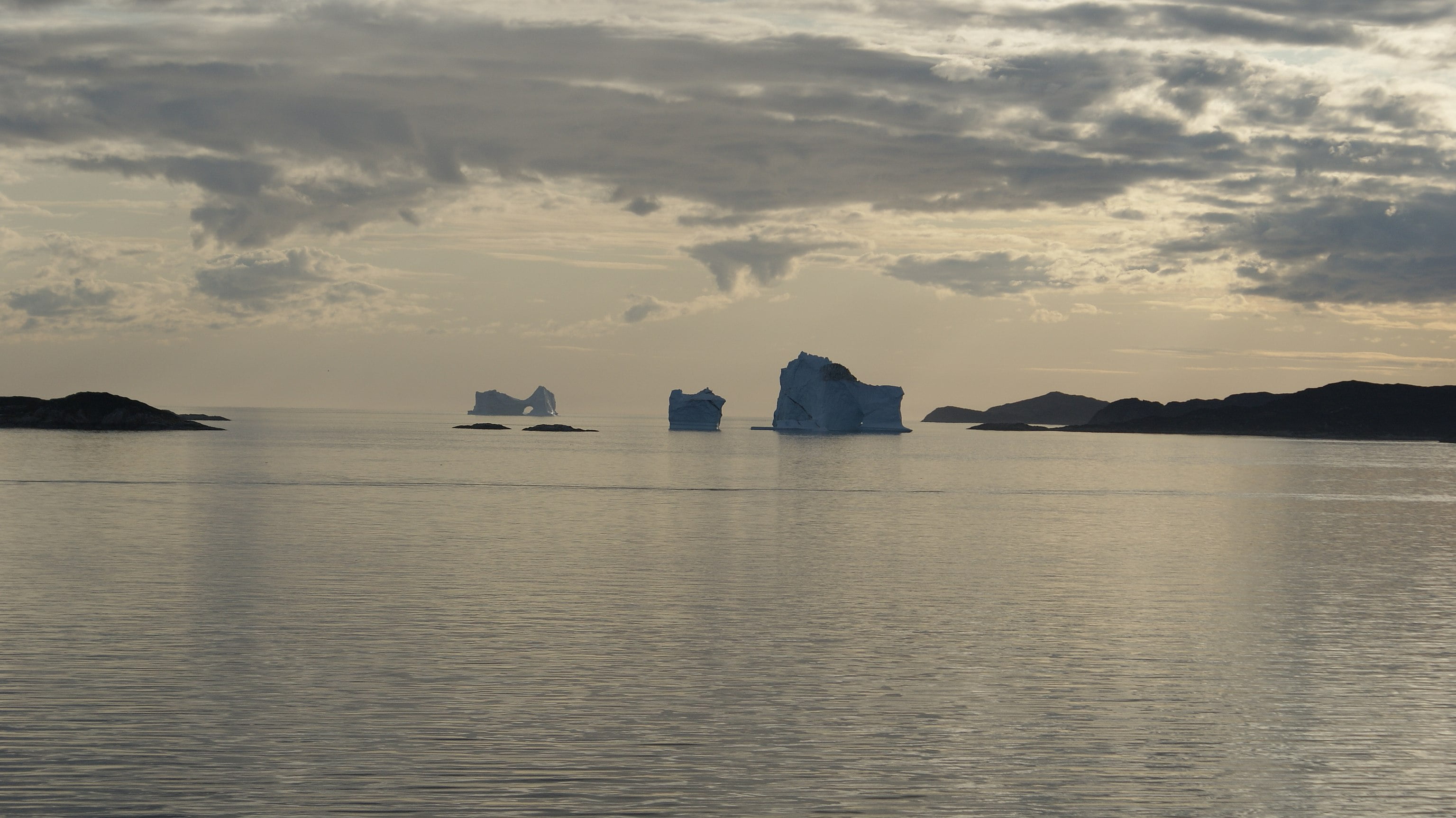 Aasiaat - Icebergs stranded in the waterways of the Aasiaat archipelago, Greenland, near the harbor in Aasiaat. Aasiaat - Icebergs stranded in the waterways of the Aasiaat archipelago, Greenland, near the harbor in Aasiaat.