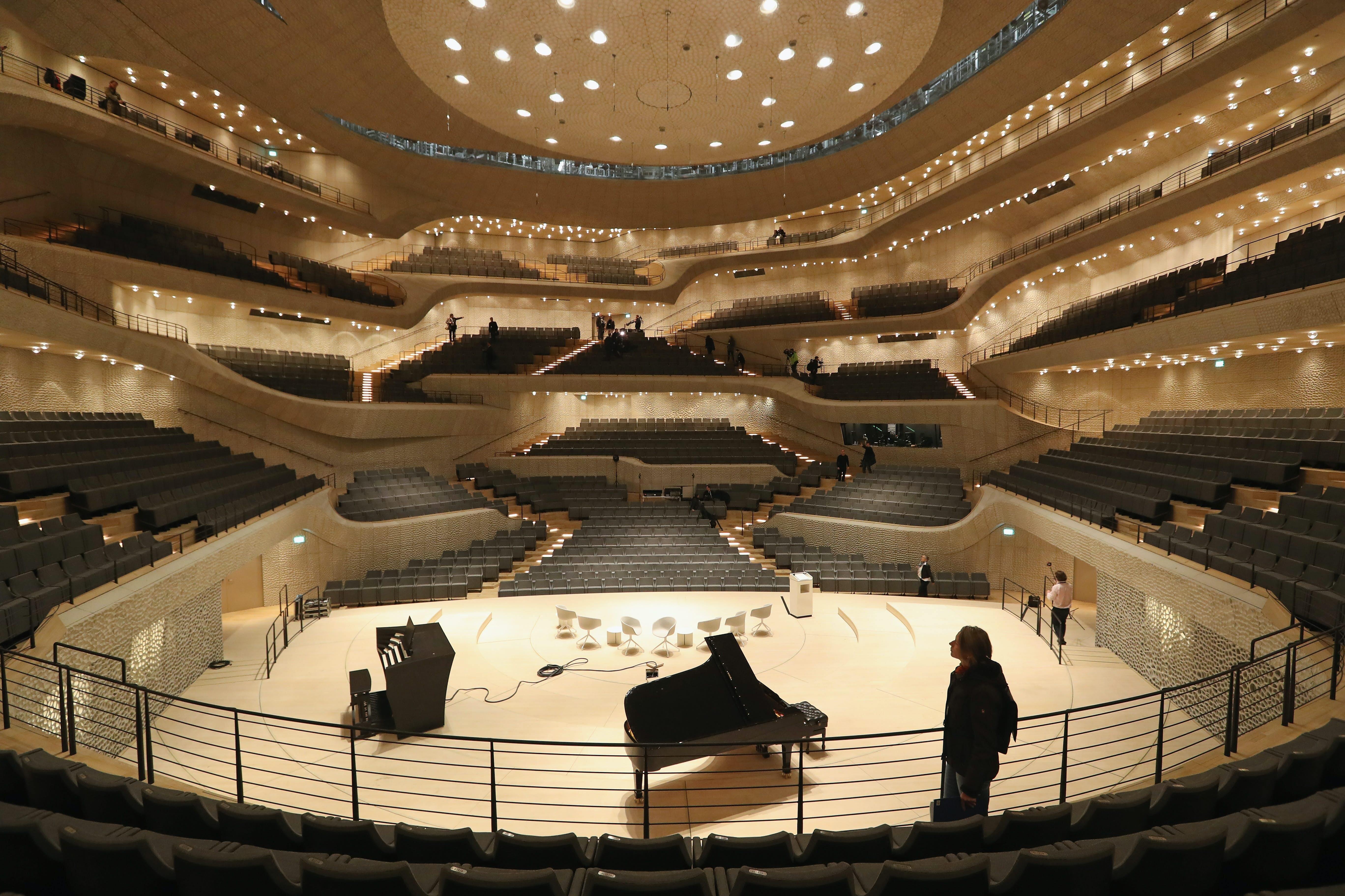 HAMBURG, GERMANY - NOVEMBER 04:  Visitors walk through the large hall of the newly-completed Elbphilharmonie concert hall on November 4, 2016 in Hamburg, Germany. Designed by the archiecture firm Herzog and de Meuron and begun in 2007, the Elbphilharmonie was originally slated to be completed by 2010 at a cost of EUR 241 million. Instead it was finally finished on October 31, 2016 at a cost of EUR 789 million. Germany has been burdened with a string of high-profile construction projects whose completion has been years delayed and whose costs have ballooned. The first public concert at the Elbphilharmonie is scheduled for January 11, 2017 as part of its official opening.  (Photo by Sean Gallup/Getty Images)